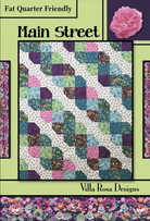 Carmon's Quilt Shop Main Street quilt pattern featuring a geometric four-patch design in floral and patterned fabrics.