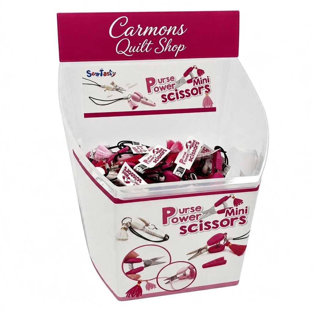 Carmon's Quilt Shop display bin filled with Sew Tasty Purse Power mini scissors featuring pink and white tassels
