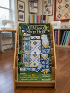 Carmon's Quilt Shop 2026 All Missouri Shop Hop magazine featuring five quilt patterns on a wooden display stand.