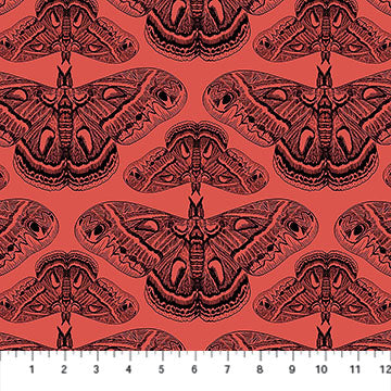 Carmon's Quilt Shop Indelible Ink fabric featuring black moth illustrations on a vibrant coral red cotton background