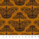 Carmon's Quilt Shop Indelible Ink fabric featuring black moth illustrations on a deep mustard yellow background