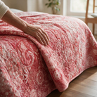 Carmon's Quilt Shop Mystique Blender rose floral cotton fabric used as a textured quilt backing on a bed