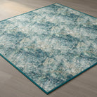 Carmon's Quilt Shop Northcott Smooth Sailing marble pattern quilt fabric in teal, blue, and white on a wood floor.
