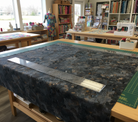 Carmon's Quilt Shop Chroma Obsidian Black 108-inch wide cotton backing fabric laid out on a quilting table