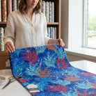 Carmon's Quilt Shop Oceana Coral 108 inch wide quilting fabric with orange and blue reef print on ocean blue background