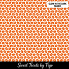 Carmon's Quilt Shop FIGO Fabrics Sweet Treat orange pumpkin cotton fabric with a glow-in-the-dark Halloween pattern.