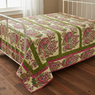 Carmon's Quilt Shop Outstretched Cream Backing 108" 100% cotton fabric with a vibrant floral pattern in pink, green, and blue.