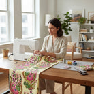 Carmon's Quilt Shop Outstretched Cream Backing 108" 100% cotton fabric with a vibrant floral pattern in pink, green, and blue.