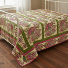 Carmon's Quilt Shop Outstretched Cream Backing 108" 100% cotton fabric with a vibrant floral pattern in pink, green, and blue.
