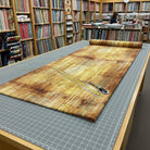 Carmon's Quilt Shop Panorama Carmel Wood 118 inch wide cotton backing fabric with a brown wood grain texture on a table
