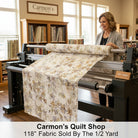 Carmon's Quilt Shop 118-inch wide Panorama tonal floral cotton fabric on a longarm quilting machine in a quilt shop.