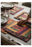 Carmon's Quilt Shop Table for Four placemats featuring colorful patchwork fabric strips on a wooden dining table