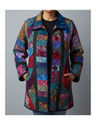 Carmon's Quilt Shop quilted patchwork jacket featuring vibrant multi-colored fabric patterns and large red buttons.