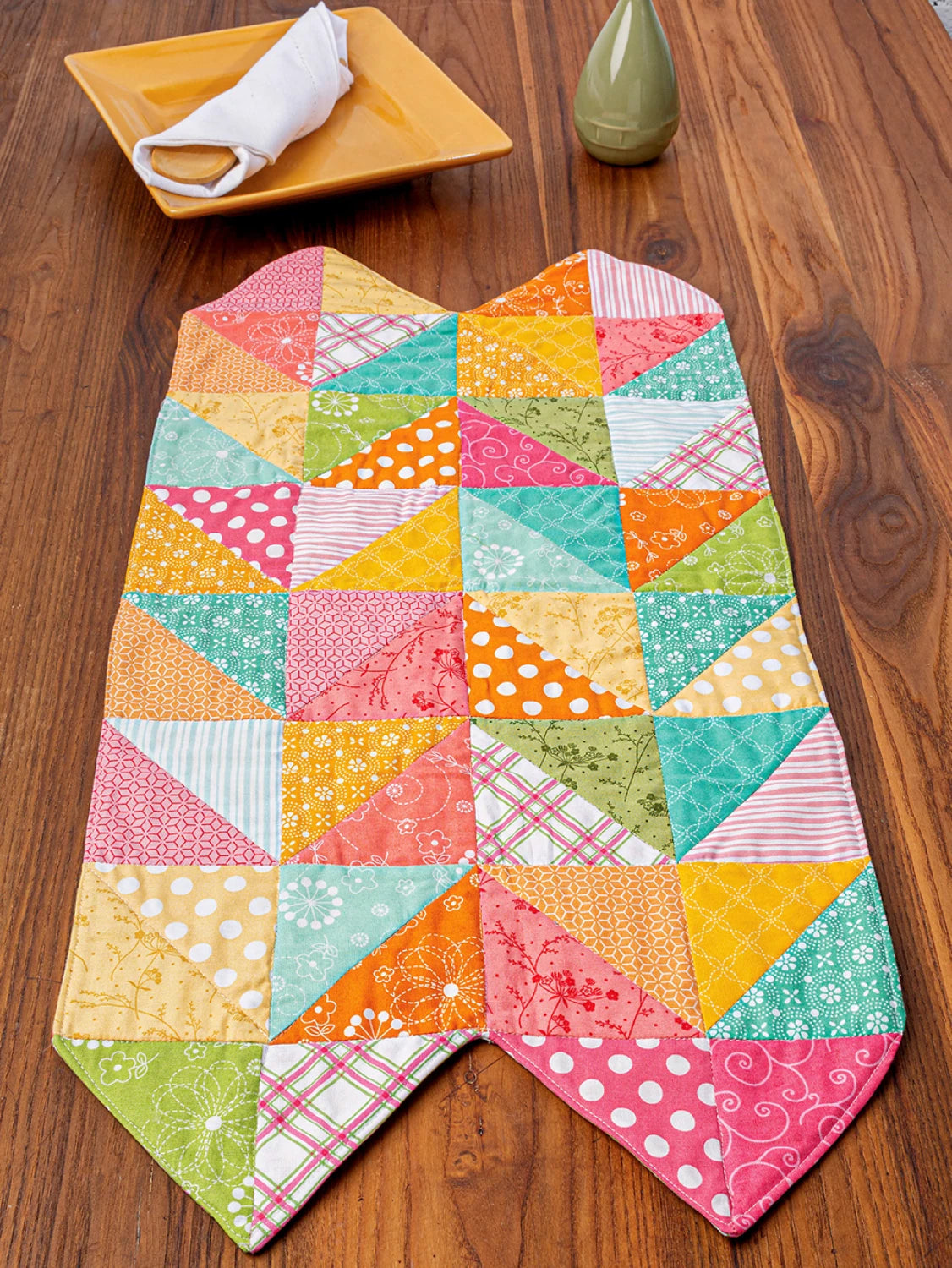 Carmon's Quilt Shop Fun With Squares pattern book project featuring a colorful geometric patchwork table runner