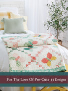 Carmon's Quilt Shop For the Love of Precuts pattern book featuring a butterfly quilt on a bed in a bright room.