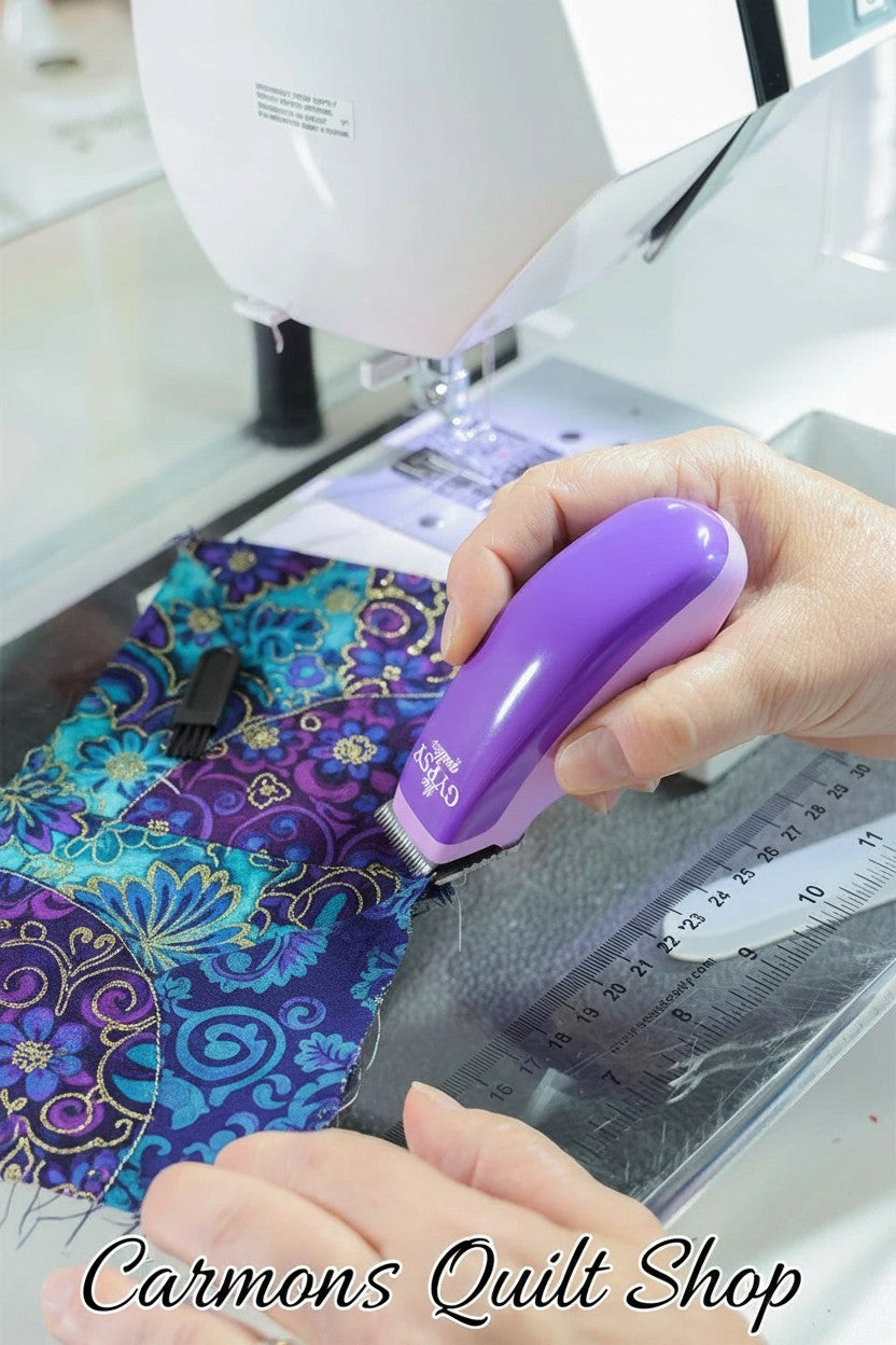 Carmon's Quilt Shop purple Gypsy Snip-N-Pin electric seam ripper removing threads from patterned fabric