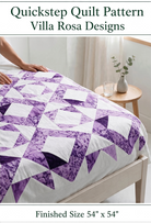 Carmon's Quilt Shop Quickstep quilt pattern featuring a purple and white interlocking diamond design on a bed.