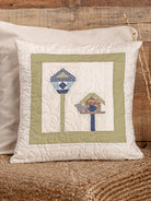Carmon's Quilt Shop decorative throw pillow featuring a quilted birdhouse design with sage green and blue accents.