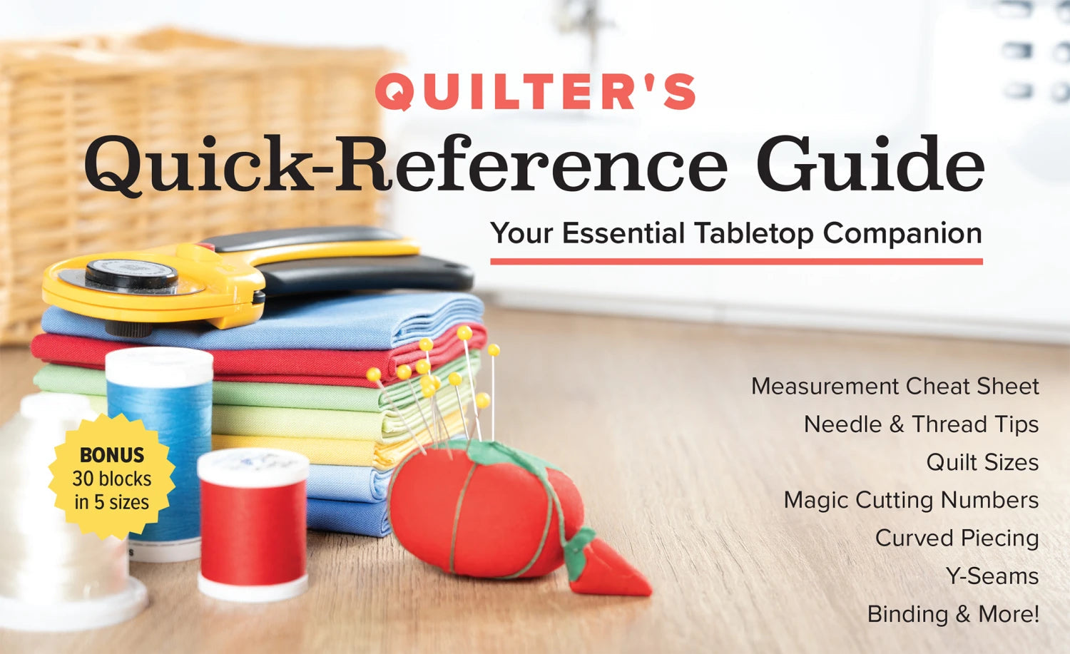 Carmon's Quilt Shop Quilter's Quick-Reference Guide tabletop book with sewing tools, fabric, and pin cushion.