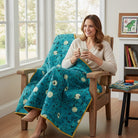 Carmon's Quilt Shop teal 100% cotton fabric panel with flying ravens and moons. Ideal for quilting.