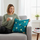 Carmon's Quilt Shop teal 100% cotton fabric panel with a flock of black birds flying against full moons and abstract feather-like patterns.