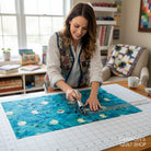 Carmon's Quilt Shop teal 100% cotton fabric panel with flying ravens and moons, ideal for quilting.