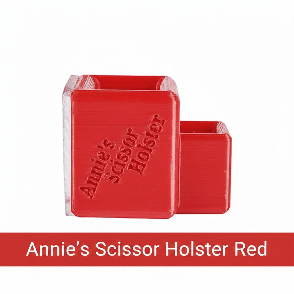 Carmon's Quilt Shop red Annie's Scissor Holster with two slots for organizing sewing tools on a craft table.