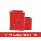 Carmon's Quilt Shop red Annie's Scissor Holster with two slots for organizing sewing tools on a craft table.