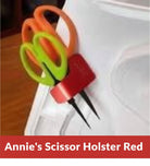 Carmon's Quilt Shop red Sew Very Smooth scissor holster with two slots holding scissors on a sewing machine