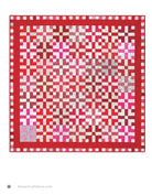 Carmon's Quilt Shop two-color red and white quilt featuring a geometric block pattern with a decorative border