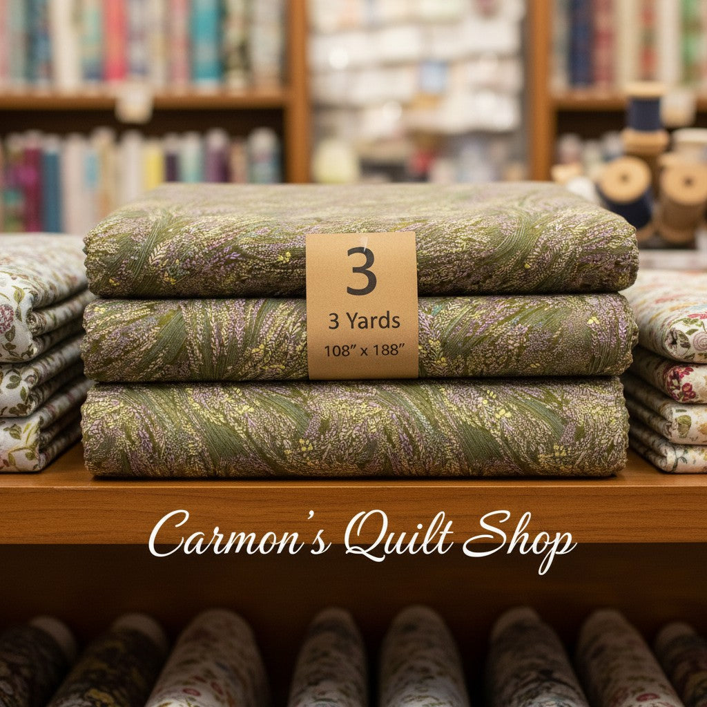 Carmon's Quilt Shop Meadow Breeze sage green floral 108-inch wide cotton quilt backing fabric folded on a shelf