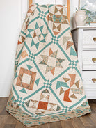Carmon's Quilt Shop Mix & Match Quilt Sampler book featuring a star-patterned quilt in teal, tan, and rust tones.