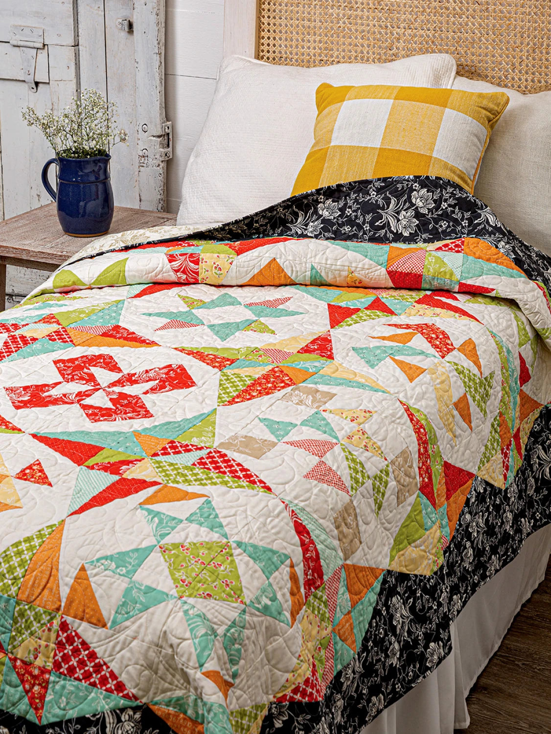 Carmon's Quilt Shop Mix & Match Quilt Sampler book featuring a colorful star-patterned quilt on a bed.
