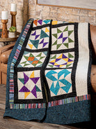 Carmon's Quilt Shop Mix & Match Quilt Sampler book featuring a colorful patchwork quilt with geometric block designs