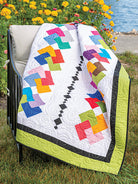 Carmon's Quilt Shop Scrap-Happy quilt pattern featuring colorful geometric fabric scraps on a white background