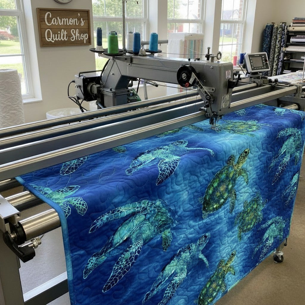Carmon's Quilt Shop sea turtle patterned 108-inch cotton fabric being machine quilted on a longarm frame