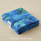 Carmon's Quilt Shop 108-inch wide blue cotton quilting fabric featuring a detailed sea turtle underwater print.