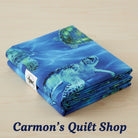 Carmon's Quilt Shop 108-inch wide cotton quilting fabric featuring a vibrant blue sea turtle underwater print.