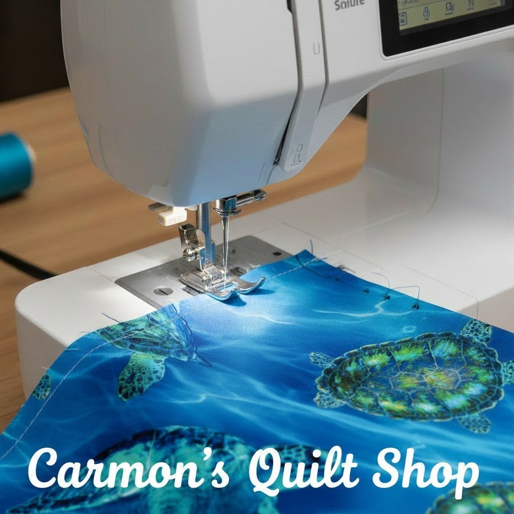 Carmon's Quilt Shop sea turtle patterned 108 inch wide cotton quilting fabric being sewn on a white sewing machine.