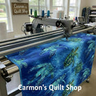 Carmon's Quilt Shop sea turtle patterned 108-inch cotton quilting fabric on a longarm quilting machine