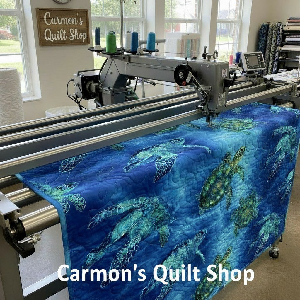 Carmon's Quilt Shop sea turtle patterned 108-inch cotton quilting fabric on a longarm quilting machine