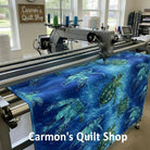 Carmon's Quilt Shop sea turtle patterned 108-inch cotton quilting fabric on a longarm quilting machine