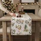 Carmon's Quilt Shop Figo Snowbound white cotton fabric featuring festive holiday icons on a quilted table runner