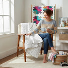 Carmon's Quilt Shop Soaring Dreams white cotton fabric with small gray stars, ideal for quilting projects.
