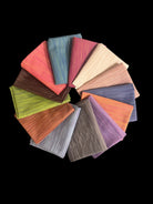 Carmon's Quilt Shop Figo Studio Space Dye fat quarter bundle featuring 13 colorful textured fabric pieces in a circle