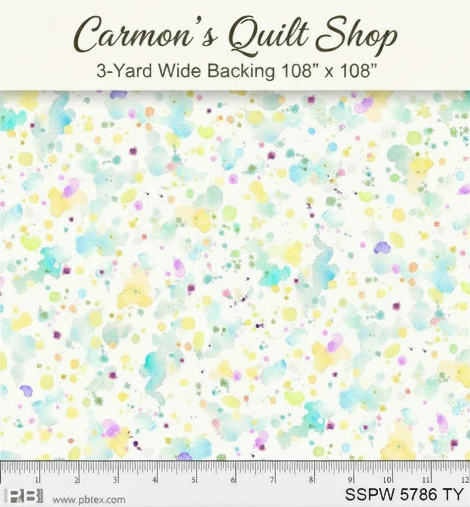 Carmon's Quilt Shop 108-inch wide cotton fabric featuring a colorful paint splatter design on a white background.