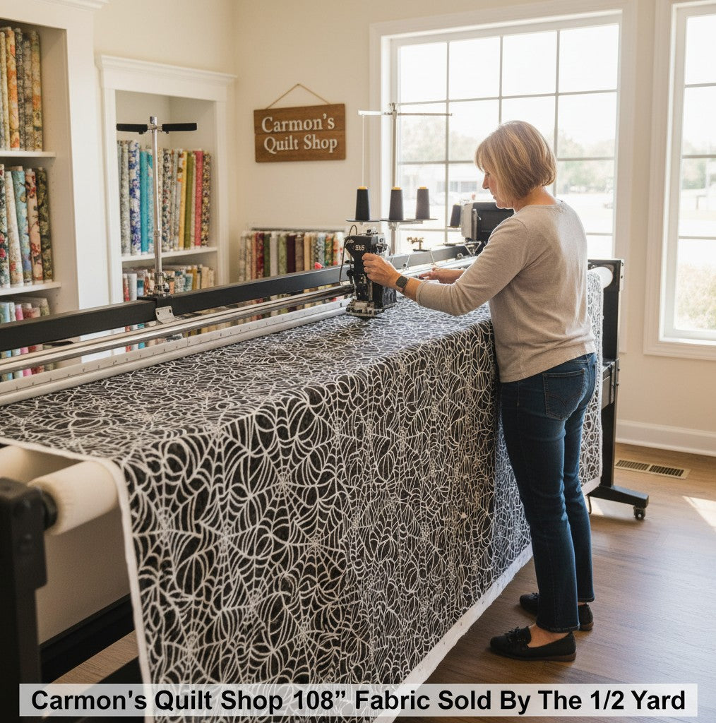 Carmon's Quilt Shop 108-inch black cotton fabric with white spiderweb print on a longarm quilting machine