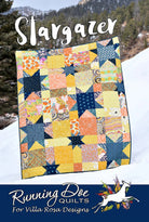 Carmon's Quilt Shop Stargazer quilt featuring a colorful star pattern made from fat quarters in a snowy outdoor setting