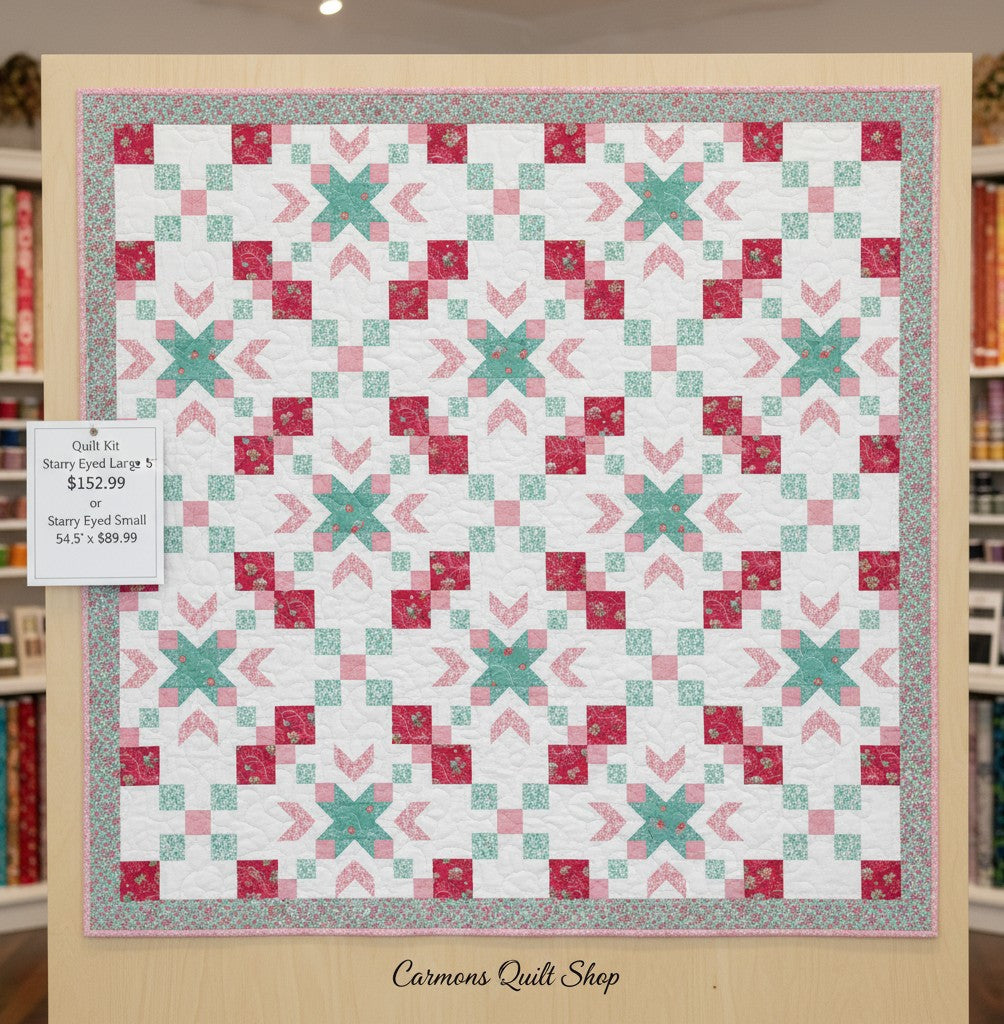 Carmon's Quilt Shop Starry-Eyed quilt kit featuring floral 100% cotton fabric in pink, teal, and white patterns.