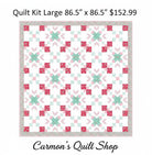 Carmon's Quilt Shop Starry-Eyed floral quilt kit in pink and teal 100% cotton fabric with a geometric star pattern.